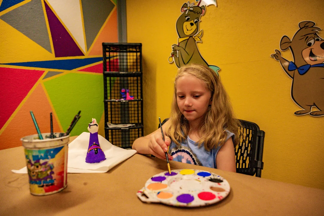 Girl painting at Craft Shack